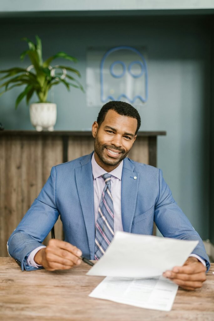 A Man in a Suit Holding Documents